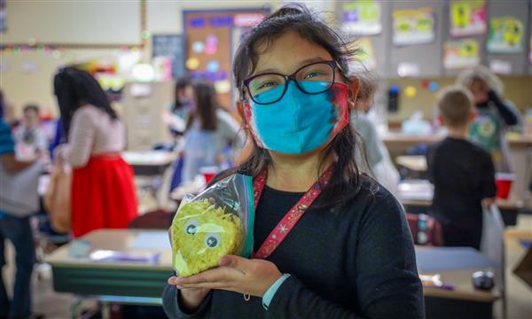 student holds up product